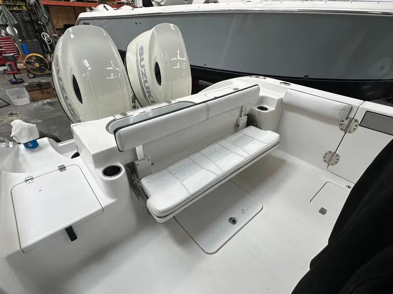 Slide: The Image of 2020 Sea Pro 259 Center Console boat interior with seating and dual engines. - 10
