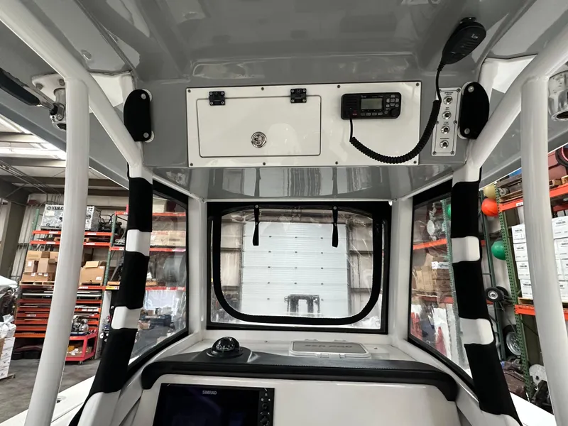 Slide: The Image of 2020 Sea Pro 259 Center Console interior with navigation equipment and storage compartments. - 11