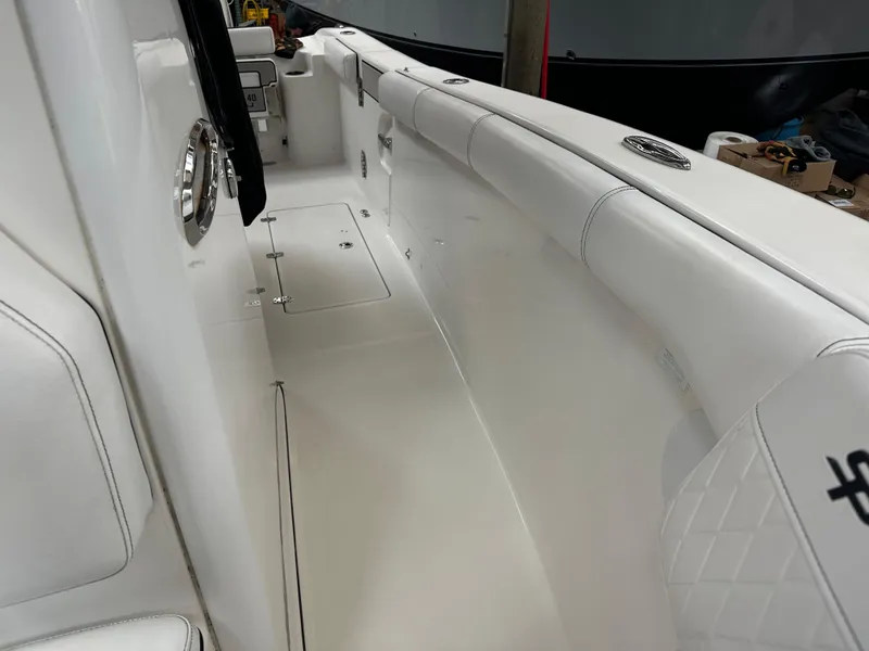 Slide: The Image of 2020 Sea Pro 259 Center Console boat interior, featuring sleek white seating and modern design. - 15