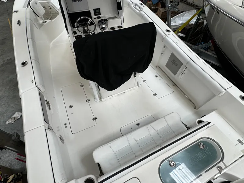 Slide: The Image of 2020 Sea Pro 259 Center Console boat interior, featuring white seating and covered helm. - 3