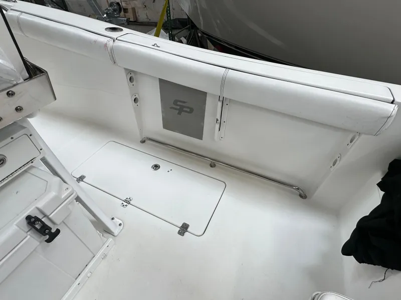 Slide: The Image of 2020 Sea Pro 259 Center Console boat interior with white seating and storage compartments. - 5