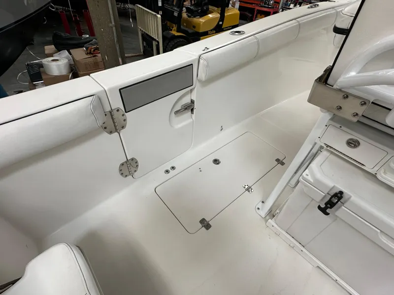 Slide: The Image of 2020 Sea Pro 259 Center Console interior, featuring white seating and storage compartments. - 7
