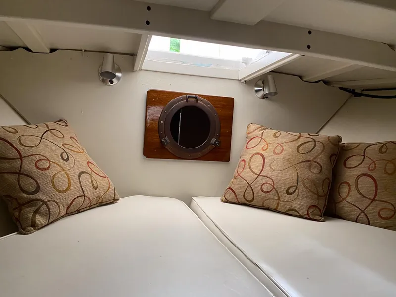Slide: The Image of 1973 Chris-Craft Sport Deck cabin interior with cushions and porthole. - 16