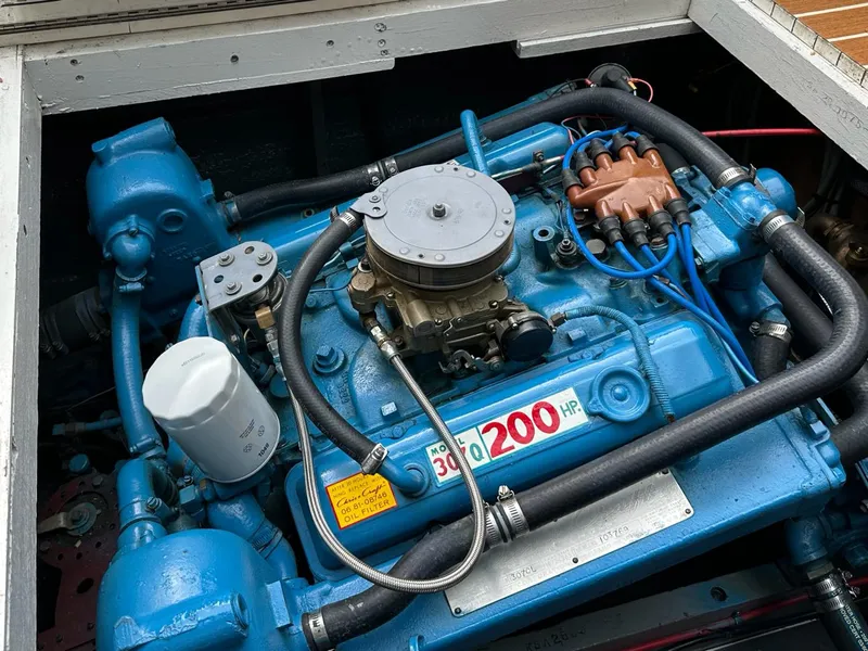 Slide: The Image of 1973 Chris-Craft Sport Deck engine, blue, labeled "300 200 HR," with visible components and wiring. - 18