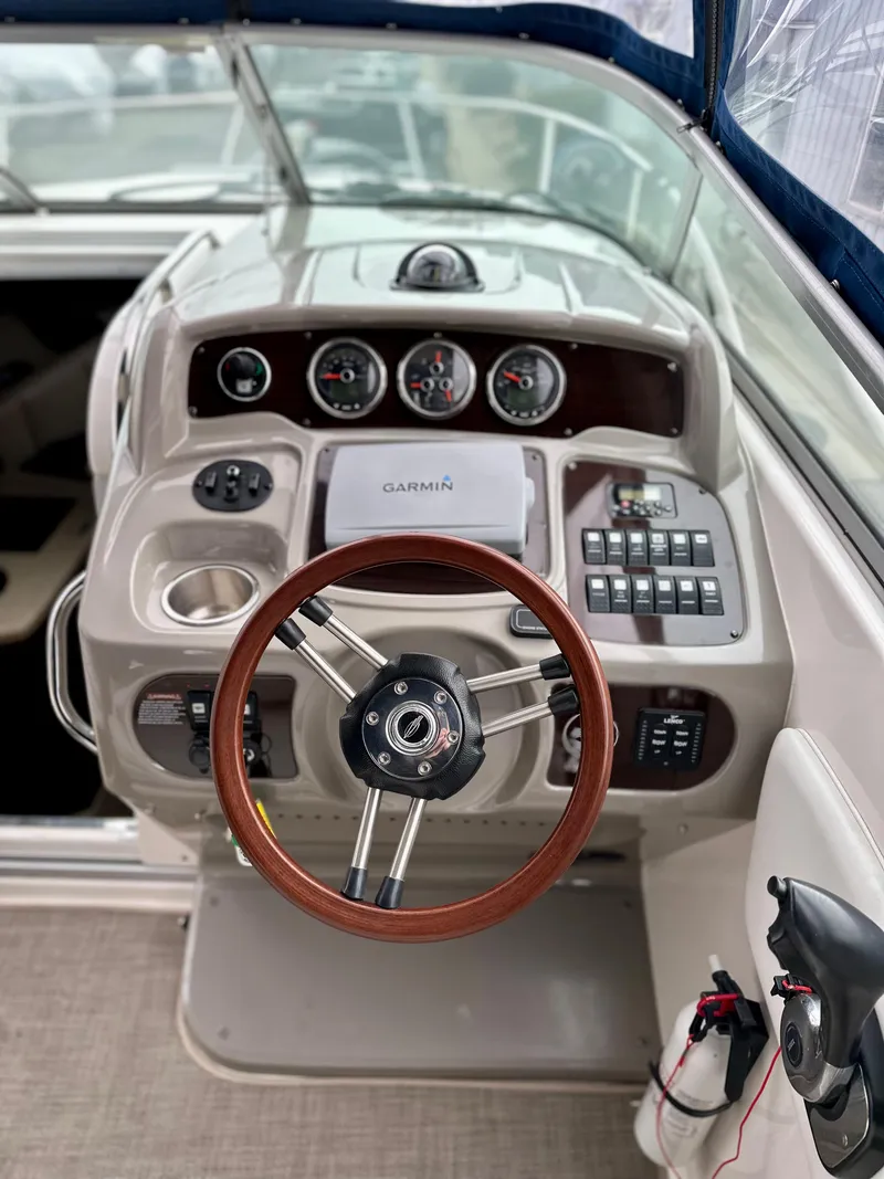 Slide: The Image of 2014 Chaparral 270 Signature boat dashboard with steering wheel and control panel. - 19