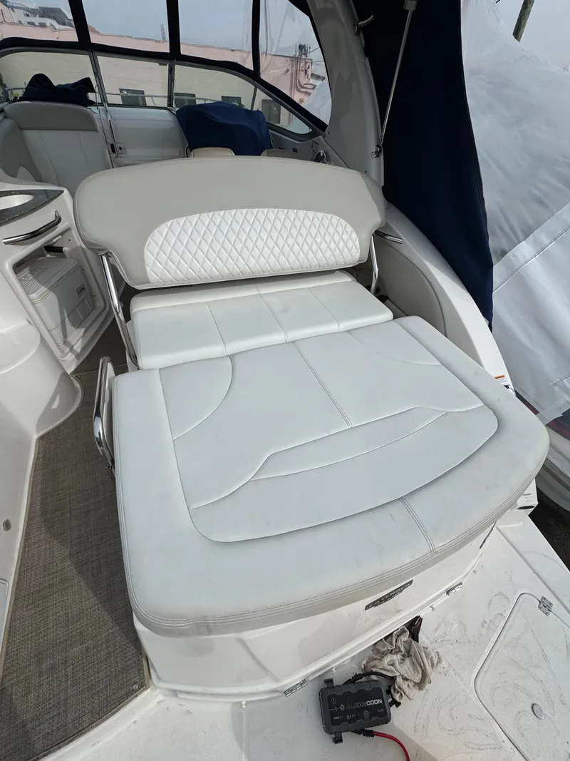 Slide: The Image of 2014 Chaparral 270 Signature boat interior with white cushioned seating. - 23
