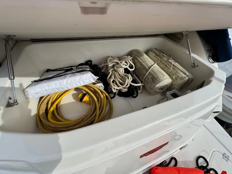 Slide: The Image of Storage compartment of 2014 Chaparral 270 Signature boat with ropes and equipment. - 29