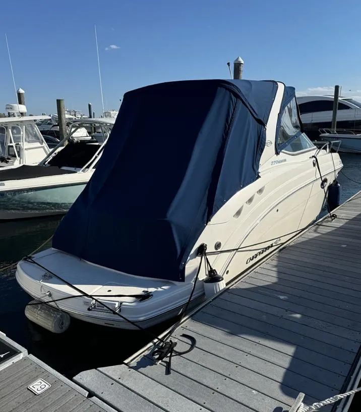 Slide: The Image of 2014 Chaparral 270 Signature boat docked with blue cover, sunny day. - 4