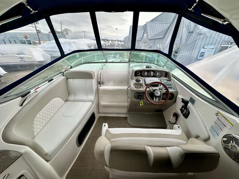 Slide: The Image of Interior of a 2014 Chaparral 270 Signature boat with seating and dashboard. - 5