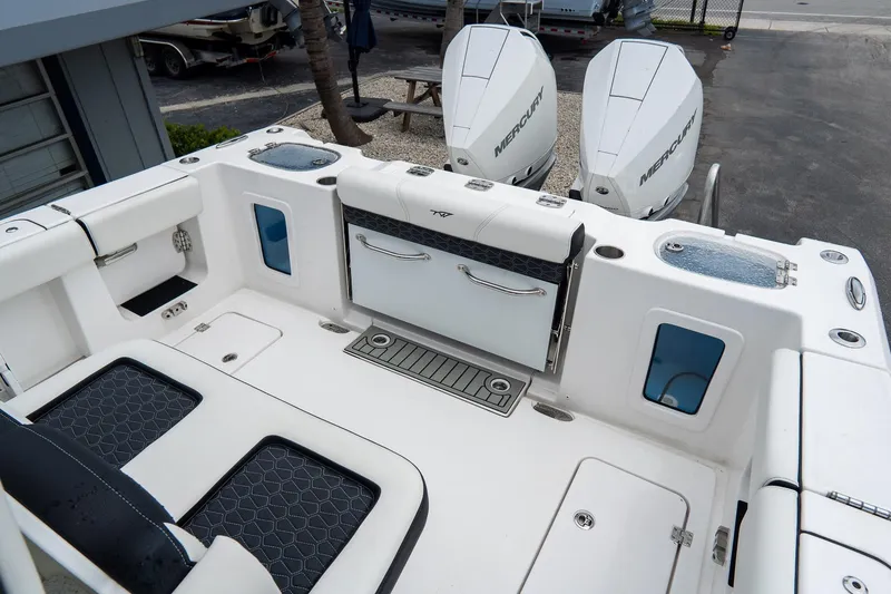 Slide: The Image of 2025 Tidewater 302CC Adventure boat with dual Mercury engines, featuring a spacious deck layout. - 17