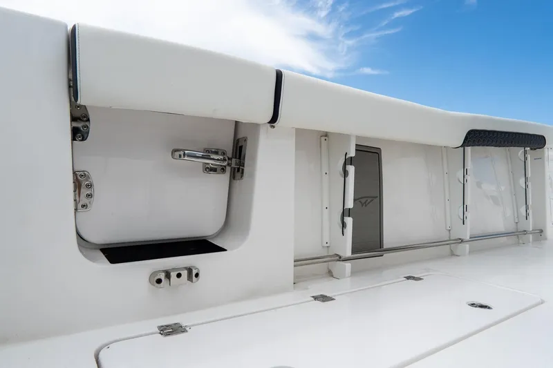 Slide: The Image of 2025 Tidewater 302CC Adventure boat interior with storage compartments and sleek design. - 18