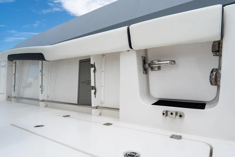 Slide: The Image of 2025 Tidewater 302CC Adventure boat interior with storage compartments and sleek design. - 19