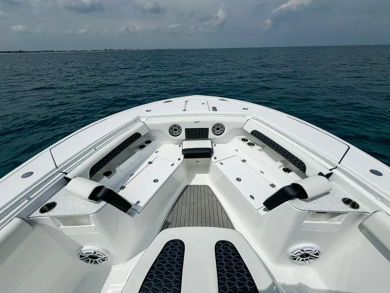 Slide: The Image of 2025 Tidewater 302CC Adventure boat interior with seating, on open water. - 7