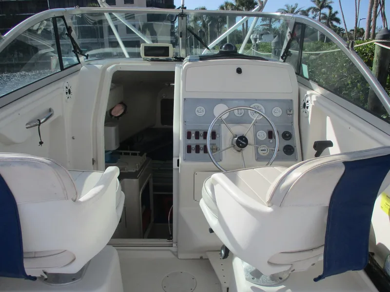 Slide: The Image of 1997 Pro-Line 251 WA boat interior with steering wheel and seating. - 10
