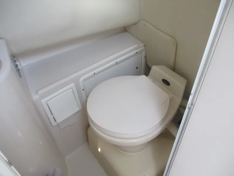 Slide: The Image of 1997 Pro-Line 251 WA boat bathroom interior with compact toilet. - 15