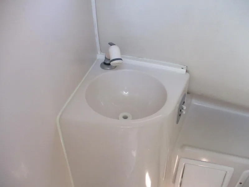 Slide: The Image of 1997 Pro-Line 251 WA boat bathroom sink with white faucet and compact design. - 16