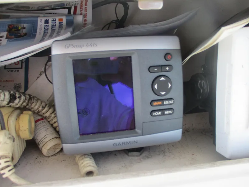 Slide: The Image of Garmin GPS device inside a 1997 Pro-Line 251 WA boat compartment. - 24