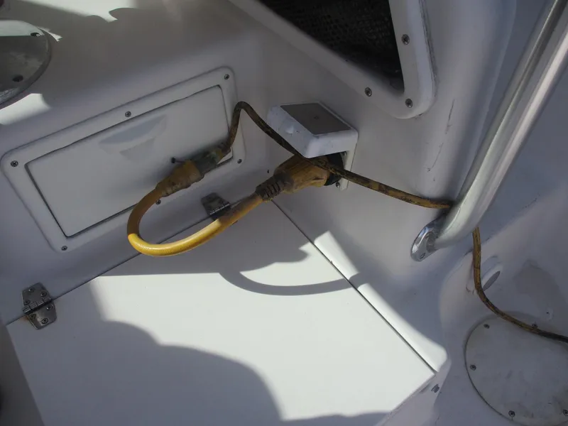 Slide: The Image of 1997 Pro-Line 251 WA boat interior with electrical wiring and storage compartment. - 25
