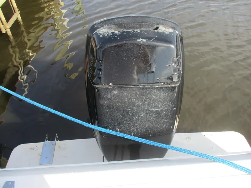 Slide: The Image of Outboard motor on a 1997 Pro-Line 251 WA boat, docked with blue rope. - 28