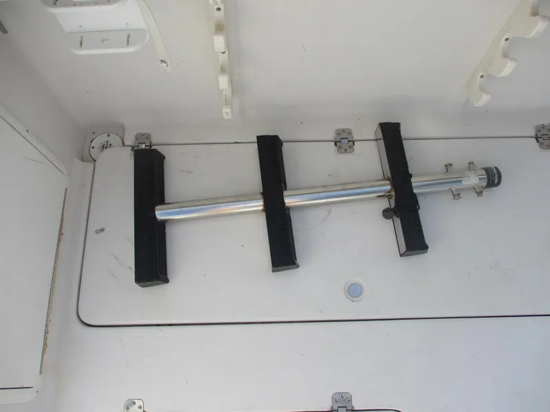 Slide: The Image of 1997 Pro-Line 251 WA boat interior with mounted metal rod holder. - 31