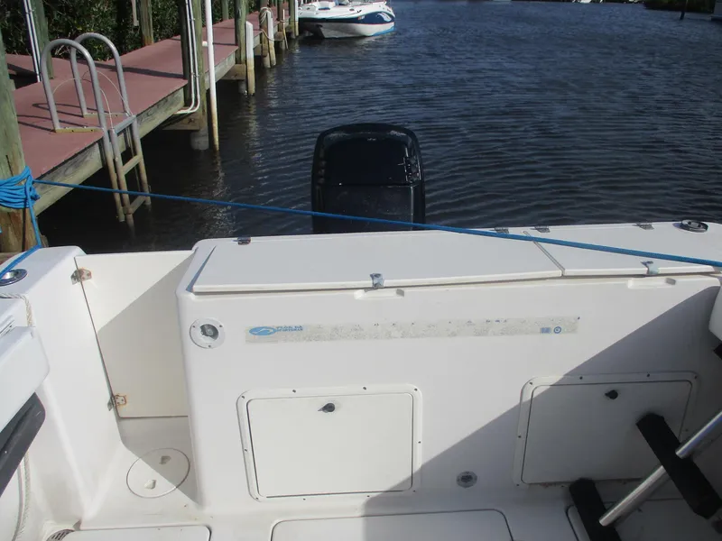 Slide: The Image of 1997 Pro-Line 251 WA boat docked by a calm waterfront. - 4