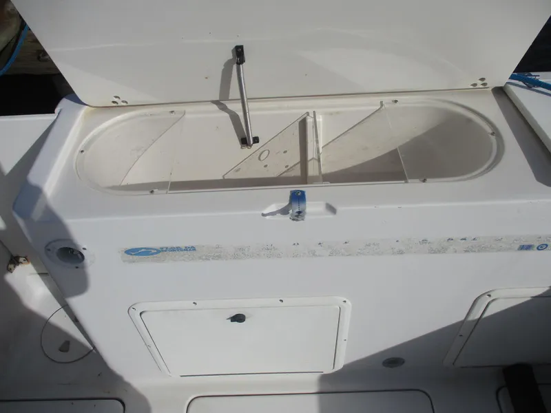 Slide: The Image of 1997 Pro-Line 251 WA boat storage compartment with open lid. - 5