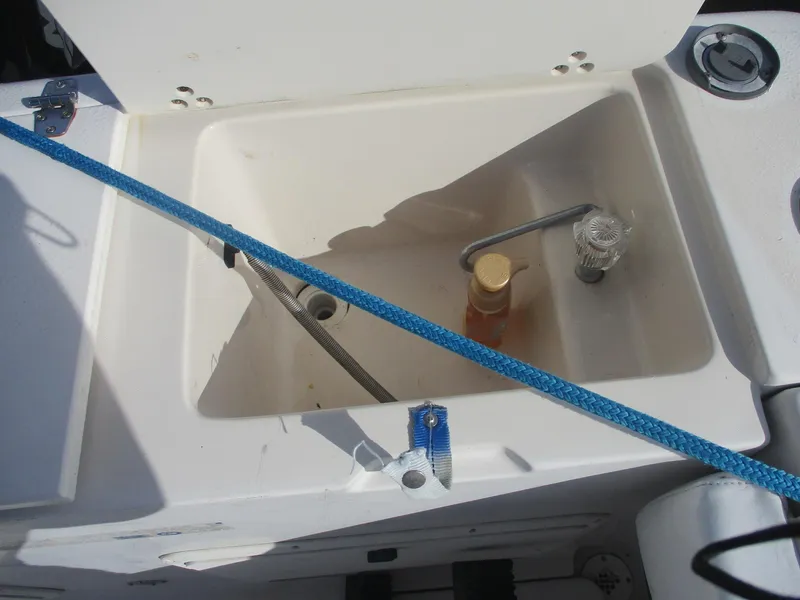 Slide: The Image of Open storage compartment on 1997 Pro-Line 251 WA boat with blue rope and bottle inside. - 6