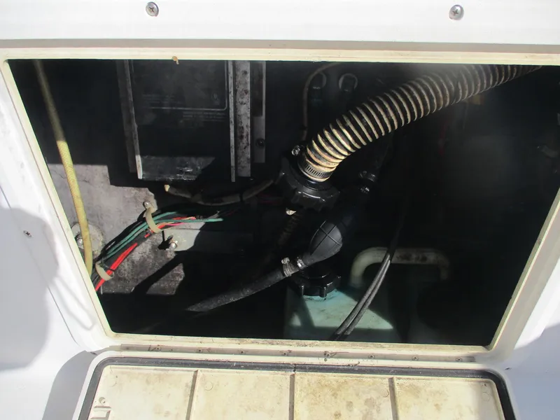 Slide: The Image of 1997 Pro-Line 251 WA boat compartment with wiring and hoses visible. - 7