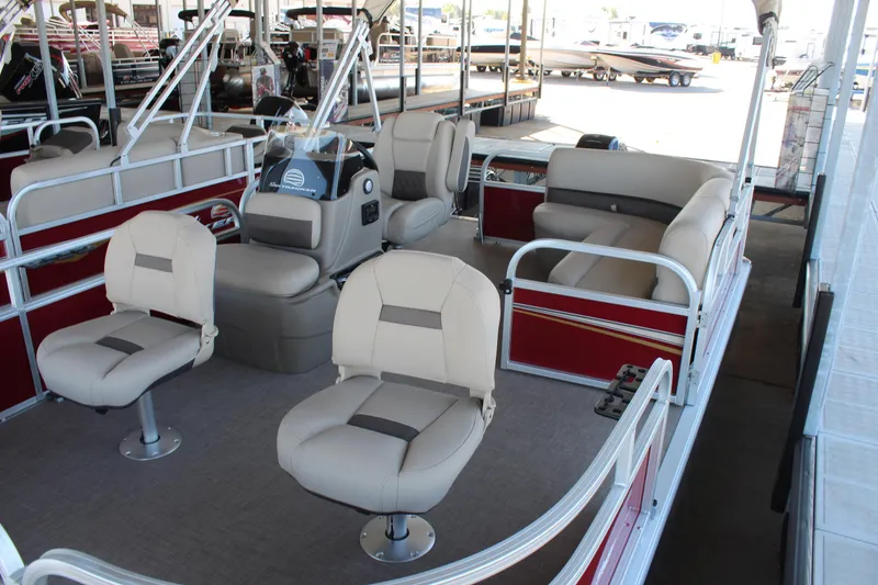 Slide: The Image of 2025 Sun Tracker Bass Buggy 16 XL Select pontoon boat interior with beige seating. - 5