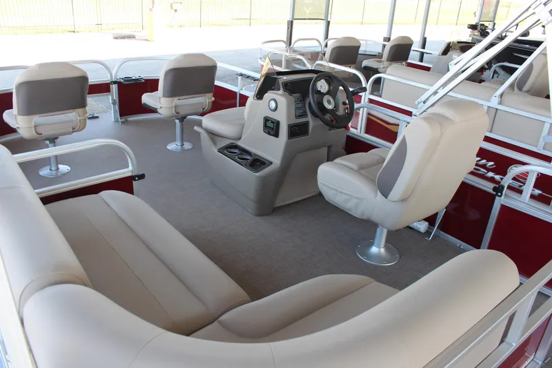 Slide: The Image of 2025 Sun Tracker Bass Buggy 16 XL Select pontoon boat interior with seating and steering console. - 6