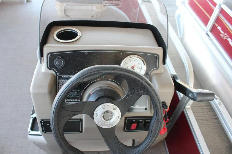 Slide: The Image of 2025 Sun Tracker Bass Buggy 16 XL Select steering console with gauge and controls. - 7