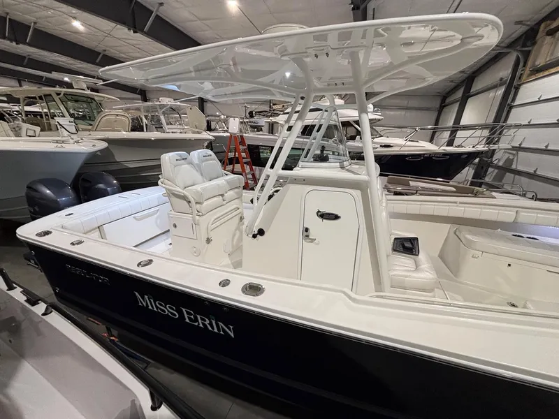 Slide: The Image of 2015 Regulator 25 boat in storage, featuring white interior and "Miss Erin" name on the side. - 10