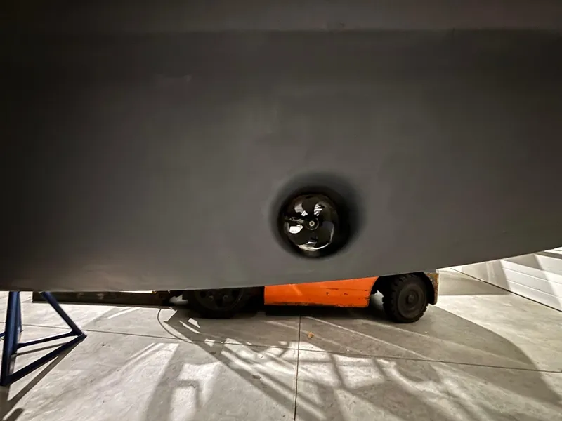 Slide: The Image of 2015 Regulator 25 boat hull with visible propeller in a garage setting. - 13