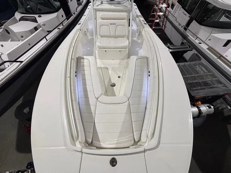 Slide: The Image of 2015 Regulator 25 boat interior with white seating and sleek design. - 14