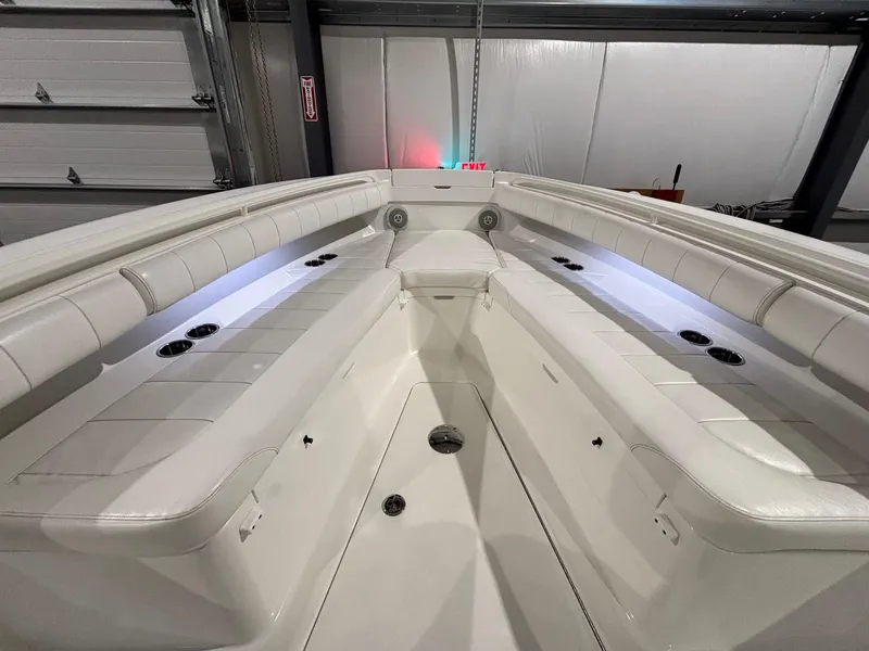 Slide: The Image of 2015 Regulator 25 boat interior with white seating and ambient lighting. - 15