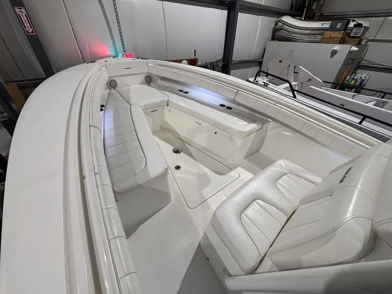 Slide: The Image of 2015 Regulator 25 boat interior with white seating in a storage facility. - 16