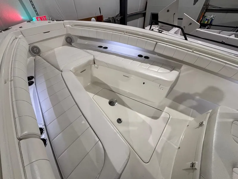 Slide: The Image of 2015 Regulator 25 boat interior with white seating and storage compartments. - 17