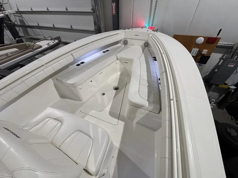 Slide: The Image of 2015 Regulator 25 boat interior with white seating and storage compartments. - 19