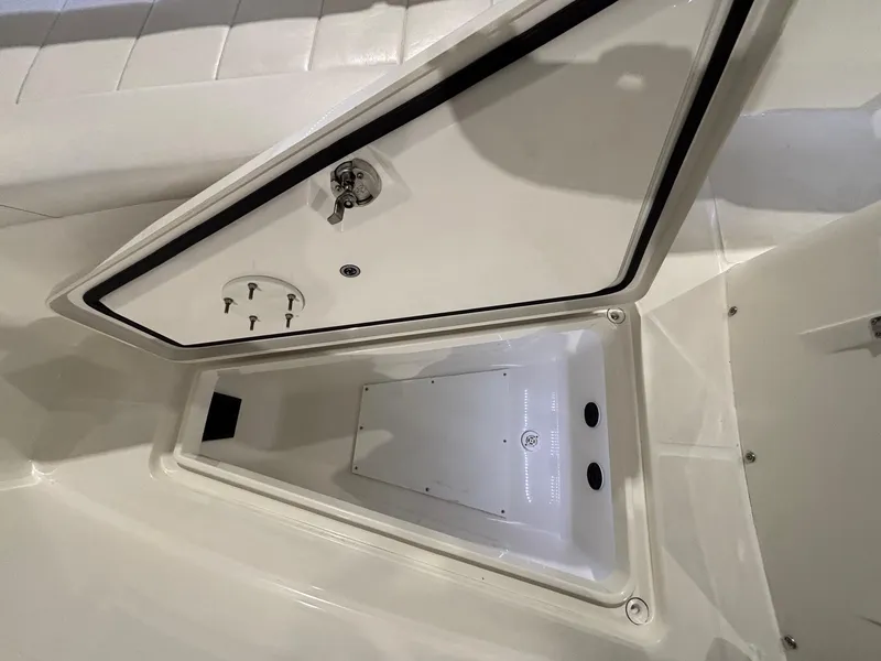 Slide: The Image of Open storage compartment on a 2015 Regulator 25 boat. - 22