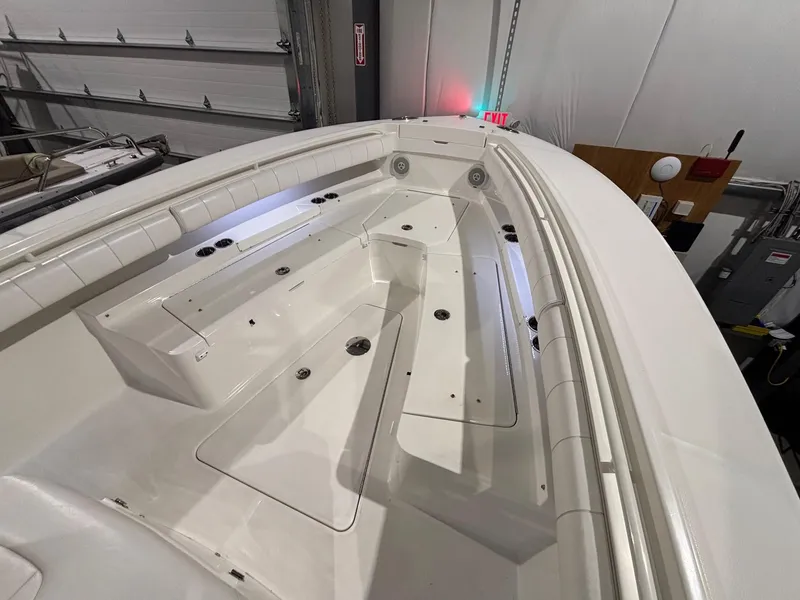Slide: The Image of 2015 Regulator 25 boat interior with storage compartments in a garage setting. - 24