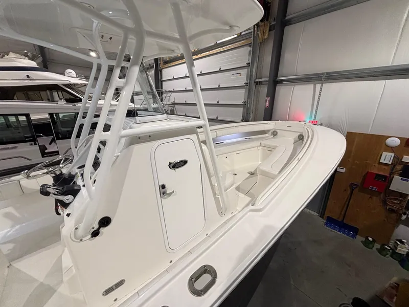 Slide: The Image of 2015 Regulator 25 boat in a garage, showcasing sleek design and spacious deck. - 36