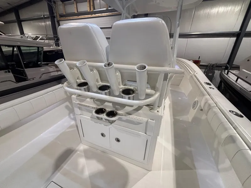 Slide: The Image of 2015 Regulator 25 boat interior with rod holders and storage compartments. - 40