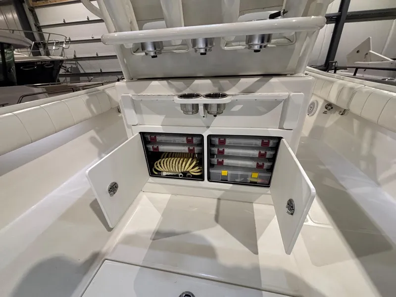 Slide: The Image of 2015 Regulator 25 boat storage compartment with open doors, showcasing organized interior. - 47