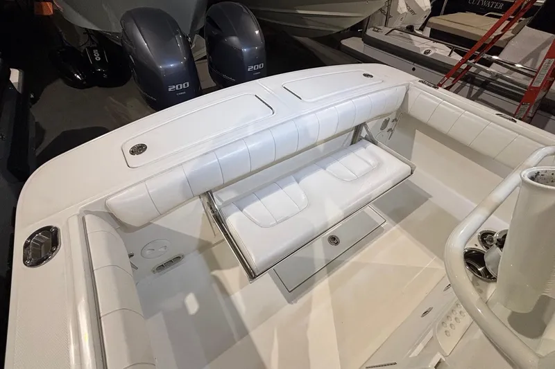 Slide: The Image of 2015 Regulator 25 boat interior with white seating and dual outboard engines. - 48