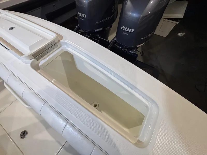 Slide: The Image of 2015 Regulator 25 boat with dual 200 horsepower engines and open storage compartment. - 49