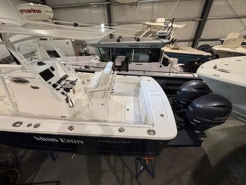 Slide: The Image of 2015 Regulator 25 boat with dual Yamaha engines in a storage facility. - 5