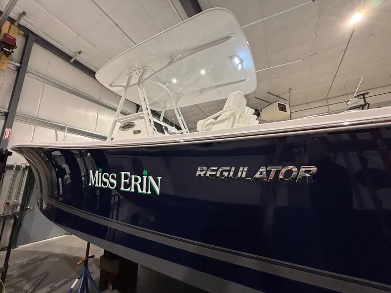 Slide: The Image of 2015 Regulator 25 boat named "Miss Erin" in a storage facility. - 8