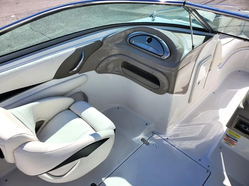 Slide: The Image of 2011 Crownline 230LS BR boat interior with white seating and sleek dashboard design. - 10