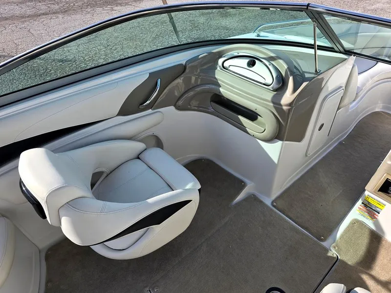 Slide: The Image of 2011 Crownline 230LS BR boat interior with sleek dashboard and comfortable seating. - 11