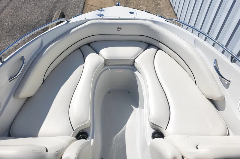 Slide: The Image of 2011 Crownline 230LS BR boat interior with white cushioned seating. - 12